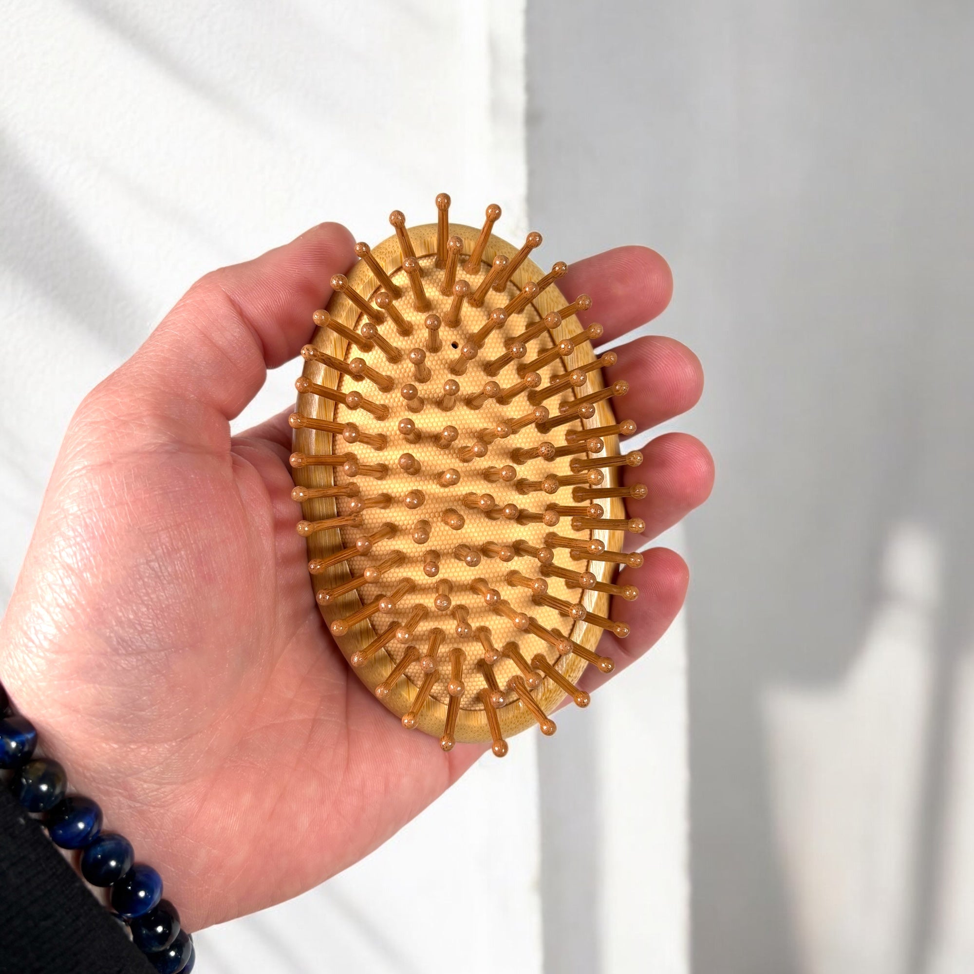 Bamboo Travel Hairbrush in hand - Bamboo Switch