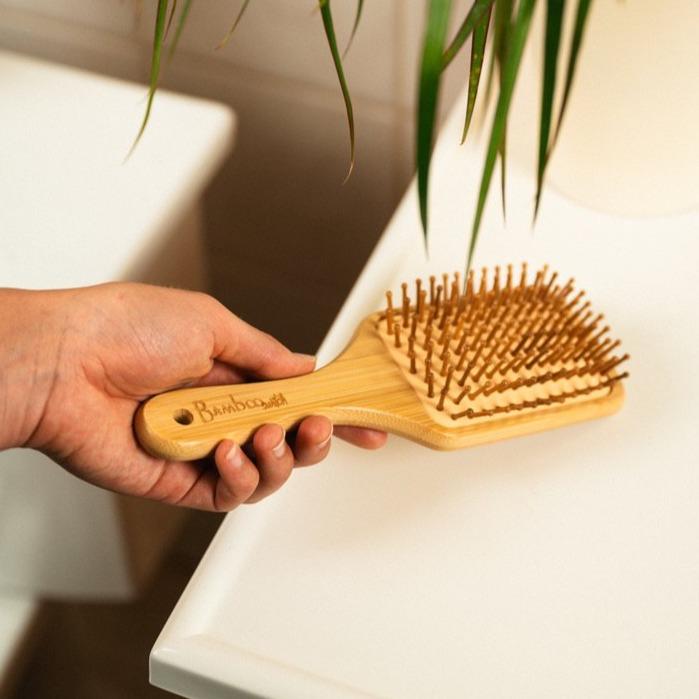 Classic Bamboo Paddle Hair Brush in hand