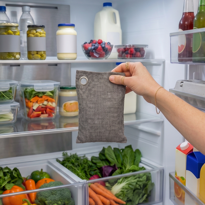 charcoal purifying bag being placed into fridge to combat food odors and humidity | Bamboo Switch
