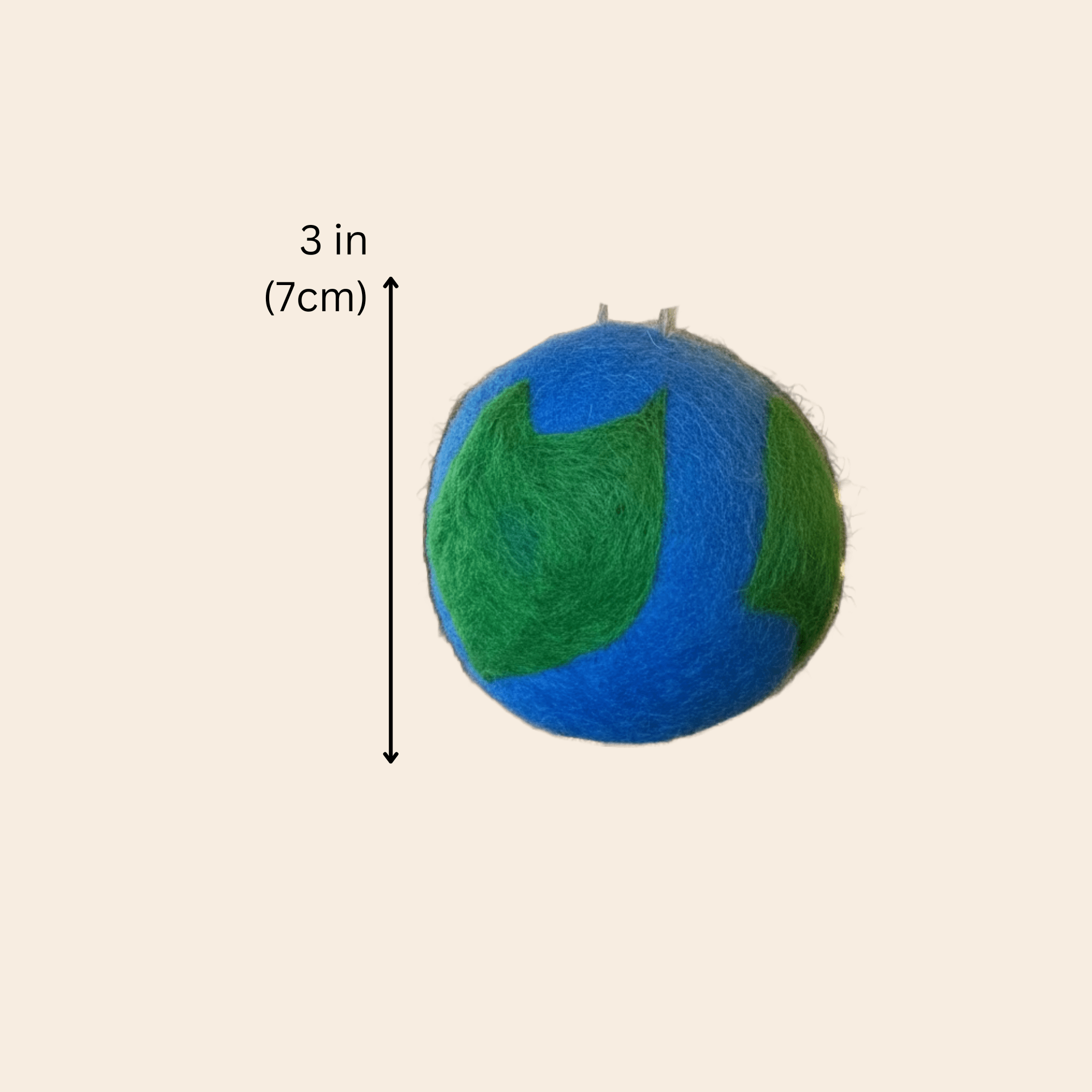 Blue and green ball with a measurement label indicating 3 inches (7cm) on a beige background