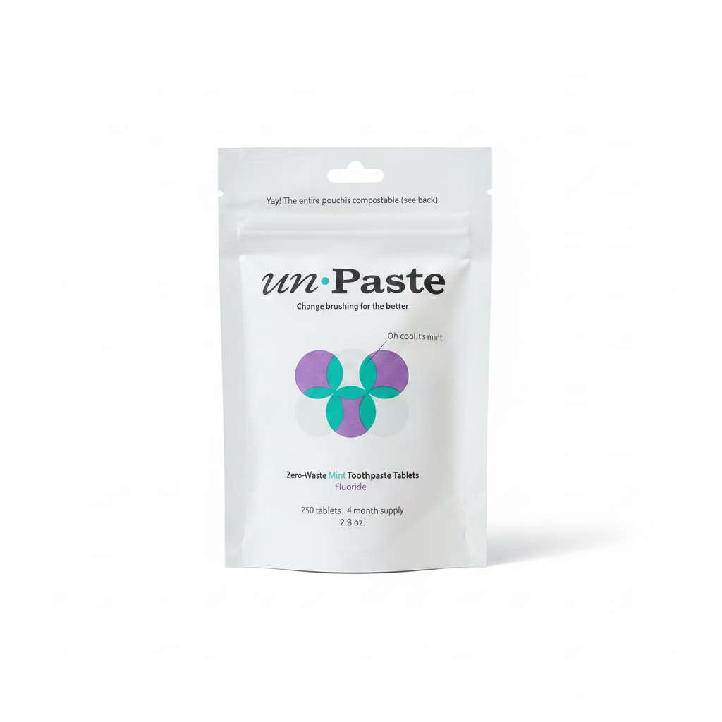 A white stand-up pouch of unPaste Toothpaste Tablets on a white background.